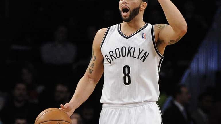 Deron Williams calls a play against the Philadelphia 76ers in...
