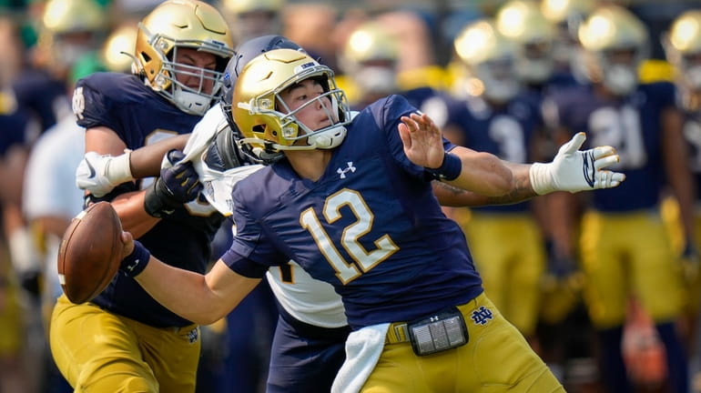 FILE - Notre Dame quarterback Tyler Buchner (12) throws while...