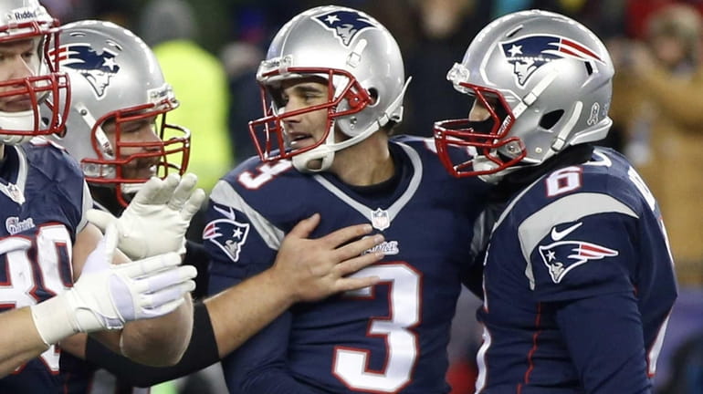 New England Patriots kicker Stephen Gostkowski, center, is congratulated after...