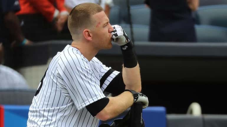 Todd Frazier of the Yankees reacts after a child was...