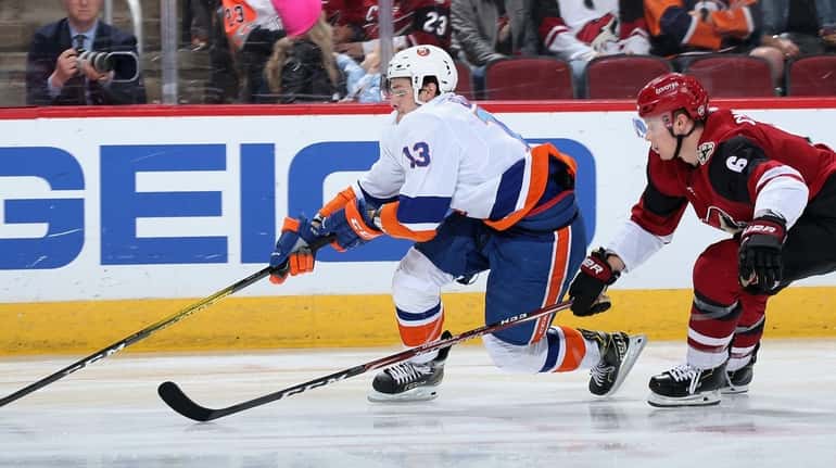 Mathew Barzal #13 of the New York Islanders skates with...
