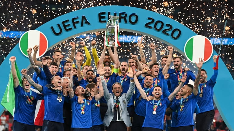FILE - Italy's team celebrates with the trophy on the...