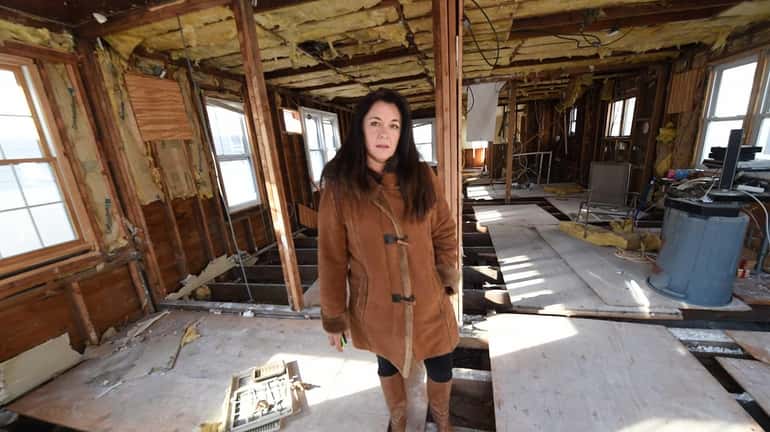 Patricia Giovinco poses at her Sandy damaged home in Long...