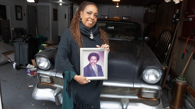 Alicia McIlwain-Marks, 60, with a picture of her father, Charles...