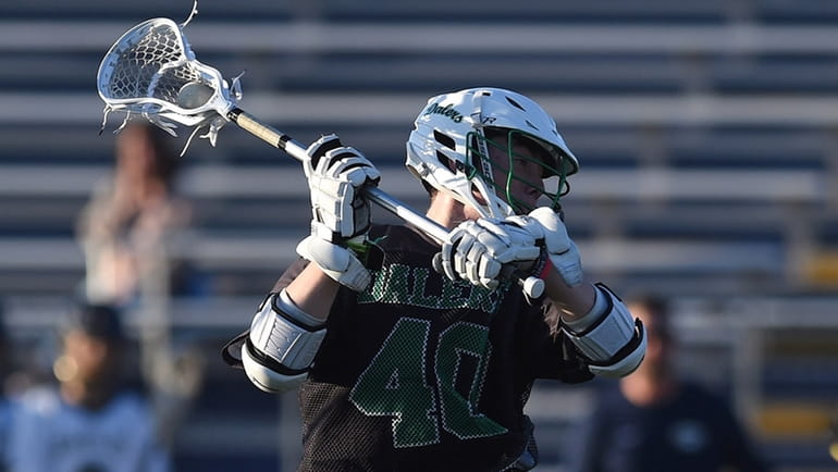 Kyle Wilson #40 of Farmingdale recoils for a shot on...