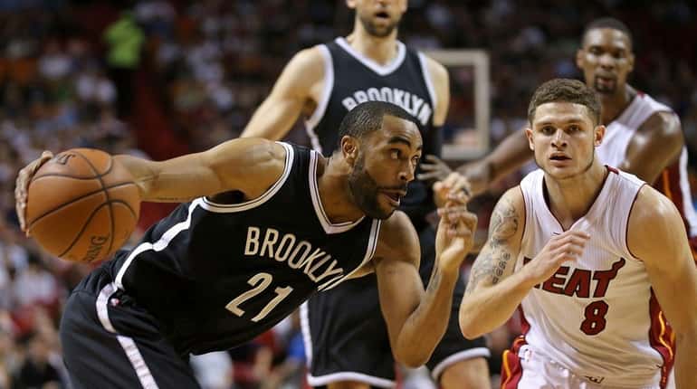 The Nets' Wayne Ellington (26 points) drives on the Heat's...