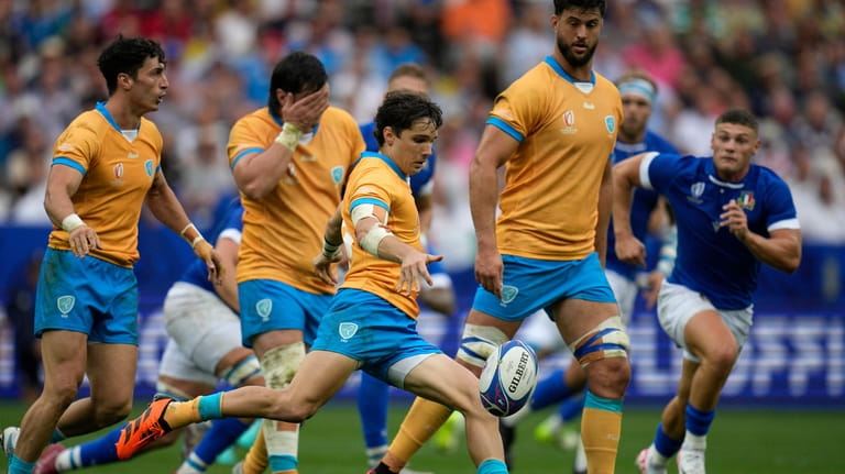 Uruguay's Felipe Etcheverry, centre, clears the ball during the Rugby...