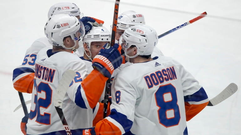 New York Islanders defenseman Andy Greene, center, celebrates with teammates...