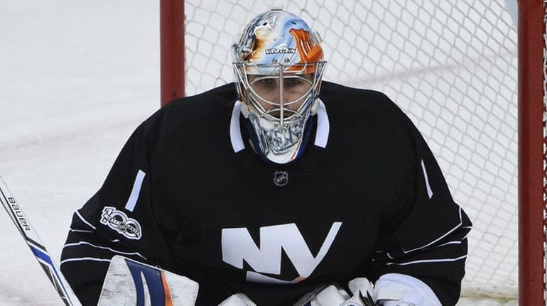 New York Islanders goalie Thomas Greiss protects the net against...