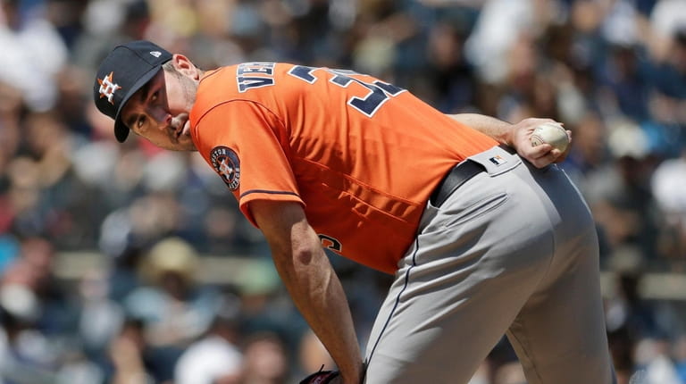 Houston Astros starting pitcher Justin Verlander looks at first base...
