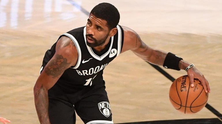 Nets guard Kyrie Irving dribbles during a preseason basketball game at...