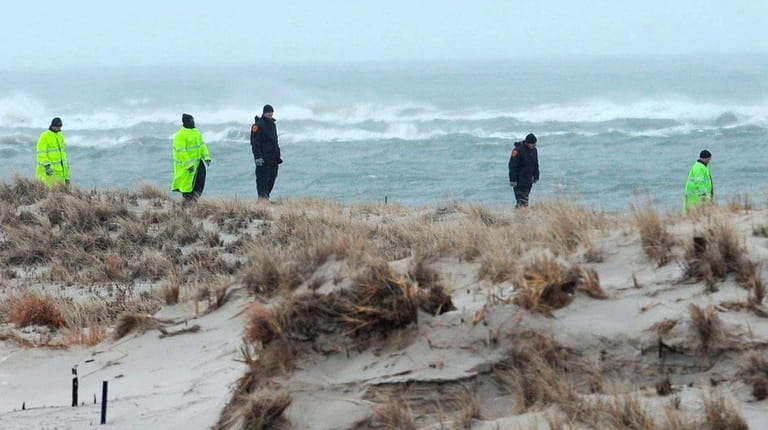Police conduct a grid search on Cedar Beach in Babylon...