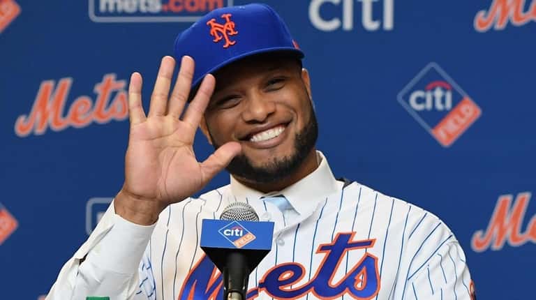 The Mets' Robinson Cano reacts during a press conference at...