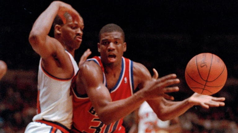 Washington's Bernard King (30) takes a pass while being guarded...