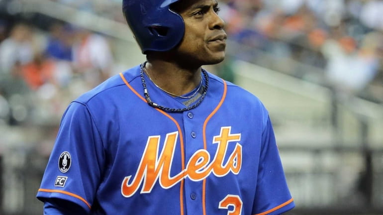 Mets rightfielder Curtis Granderson reacts as he walks back to...