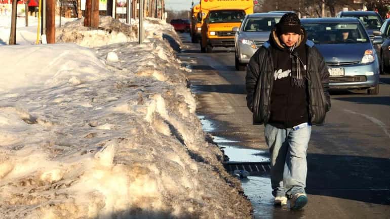 Some Long Island sidewalks are still covered with several feet...