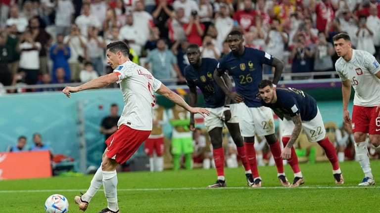 Poland's Robert Lewandowski scores on a penalty kick during the...