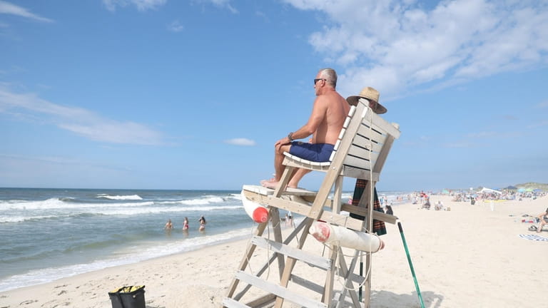 A lifeguard surveys the water Tuesday at Field 3 at Robert Moses...
