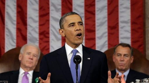 President Barack Obama, flanked by Vice President Joe Biden and...