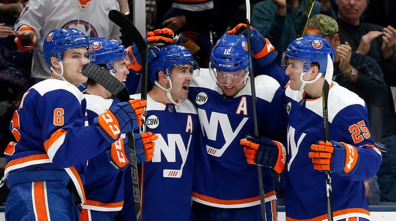 Cal Clutterbuck, No. 15, of the Islanders celebrates his first...