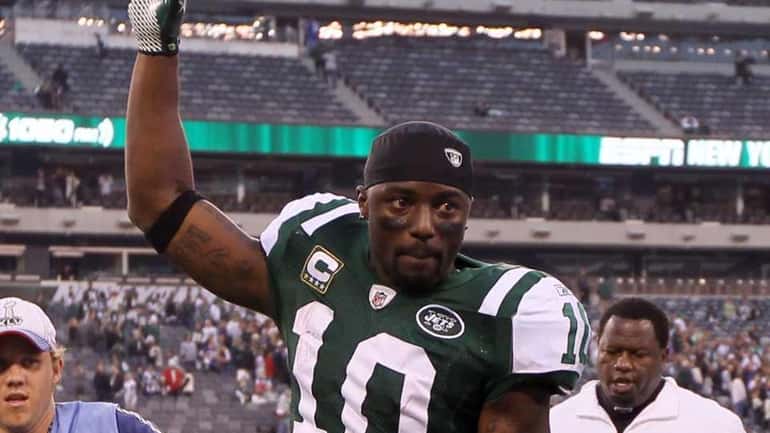 Santonio Holmes #10 of the New York Jets leaves the...