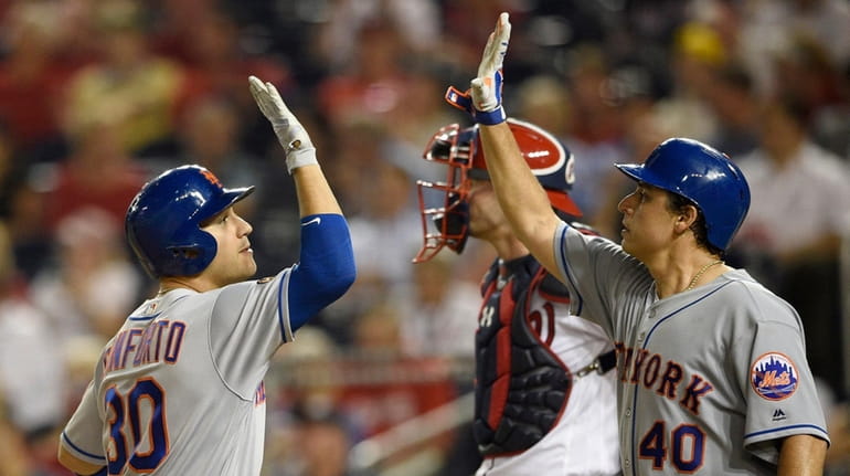 The Mets' Michael Conforto celebrates his two-run home run with Jason...