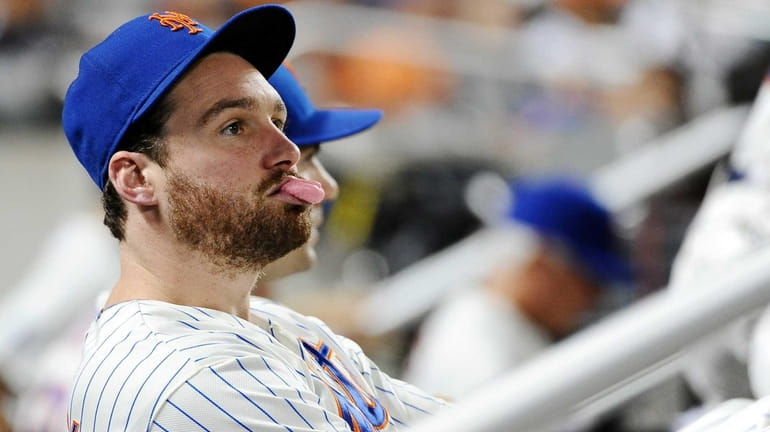 The Mets' Daniel Murphy sits in the dugout at a...
