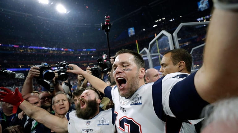 The Patriots' Julian Edelman, left, and Tom Brady celebrate winning...