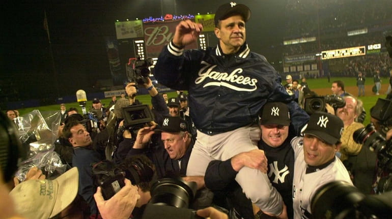 Yankees manager Joe Torre is being carried off the field...