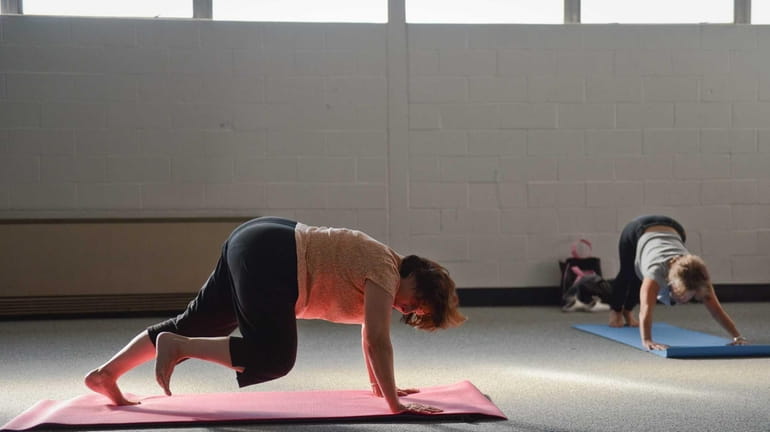 Sylvia Braun, of North Merrick, practices pilates during an adult...