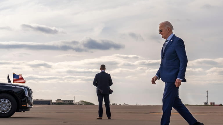 President Joe Biden walks to his motorcade after departing Air...