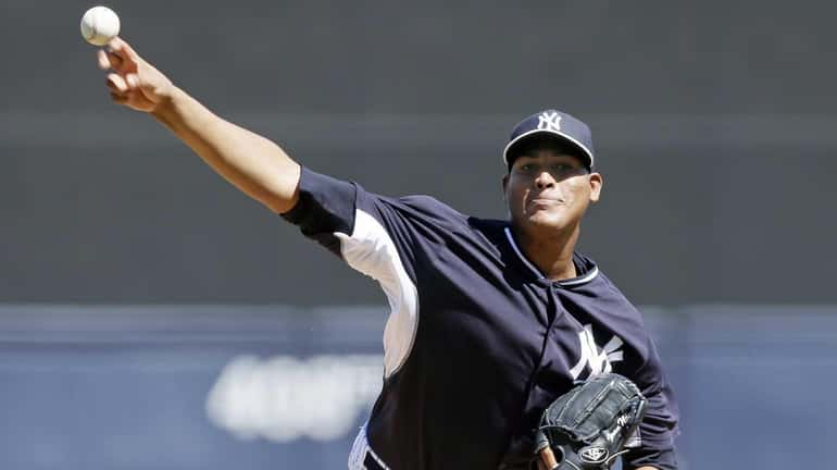 Yankees starting pitcher Ivan Nova throws during the first inning...
