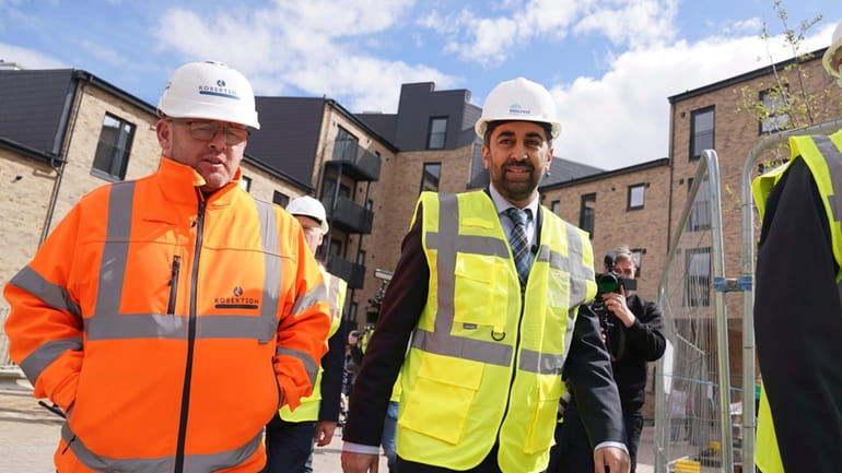 Scotland's First Minister Humza Yousaf, centre, visits the Hillcrest Homes...