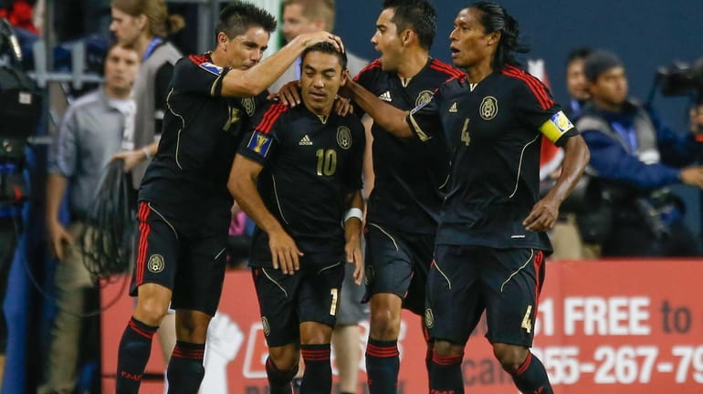 Marco Fabian (#10) of Mexico celebrates with teammates after scoring...