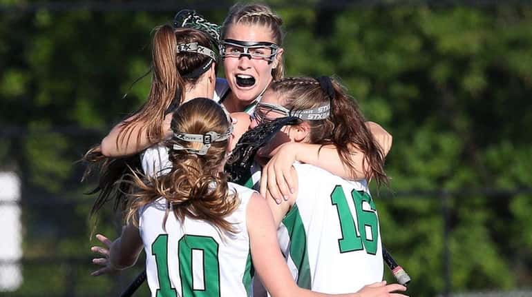 Carle Place's Abby Selhorn, center, celebrates with teammates after scoring...