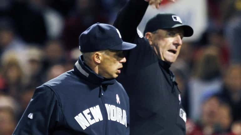 Home plate umpire Tim McClelland ejects New York Yankees manager...