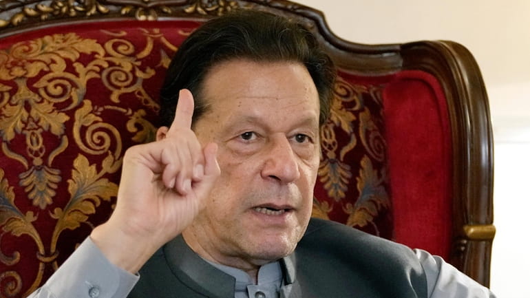 Pakistan's former Prime Minister Imran Khan gestures during talk with...