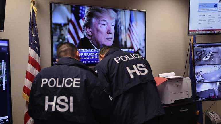 Homeland Security Investigations ICE agents work in a control center...