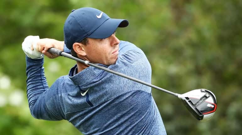 Rory McIlroy plays his shot from the 15th tee in...