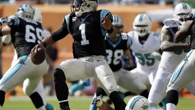 Carolina Panthers quarterback Cam Newton (1) escapes a sack by...