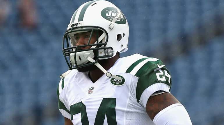 Darrelle Revis of the New York Jets warms up before...