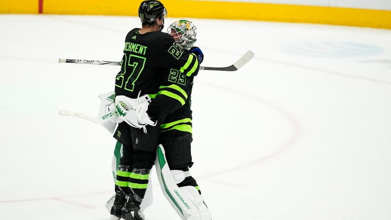 Dallas Stars' Mason Marchment (27) is lifted off the ice...