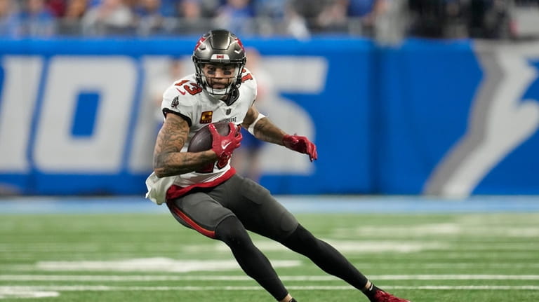 Tampa Bay Buccaneers wide receiver Mike Evans runs after making...