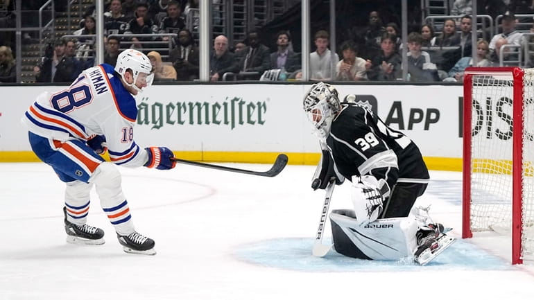 Los Angeles Kings goaltender Cam Talbot, right, deflects a shot...