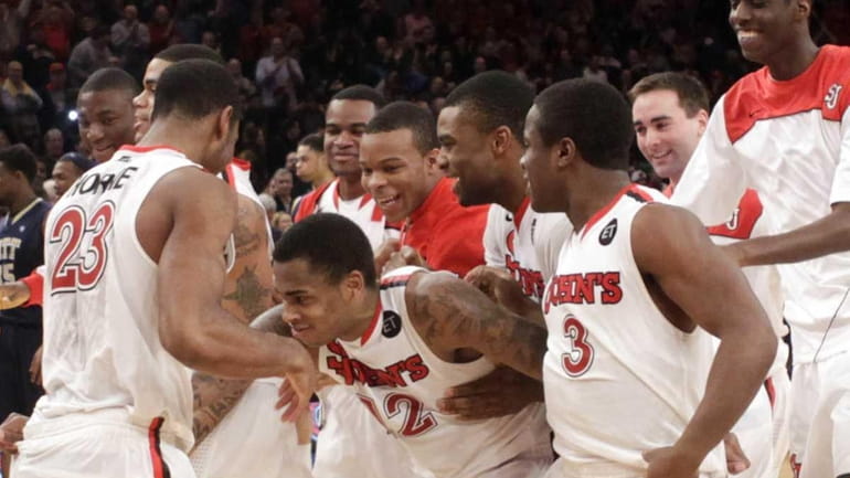 St. John's Dwight Hardy, center, celebrates with teammates after beating...