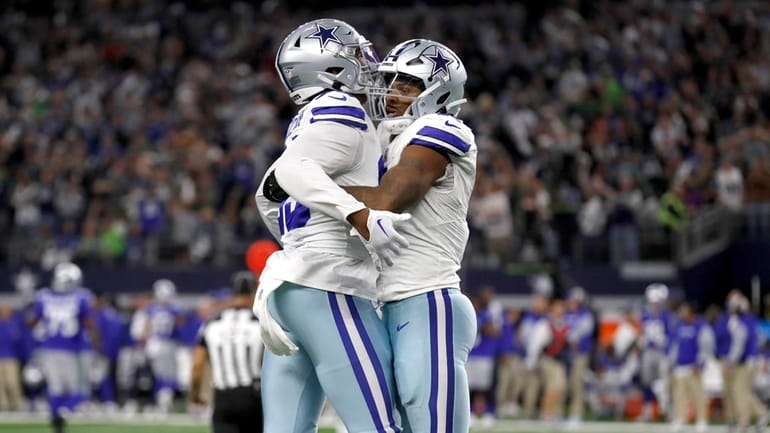 Dallas Cowboys' Chauncey Golston, left, and Micah Parsons, right, celebrate...