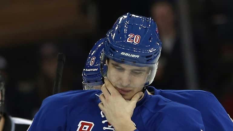 Chris Kreider leaves the ice after being hit by Brooks...