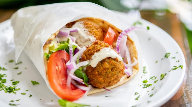The falafel sandwhich comes on a pita with tahini sauce...