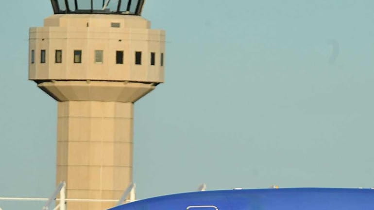 A Southwest Airlines 737 plane taxis past the air traffic...