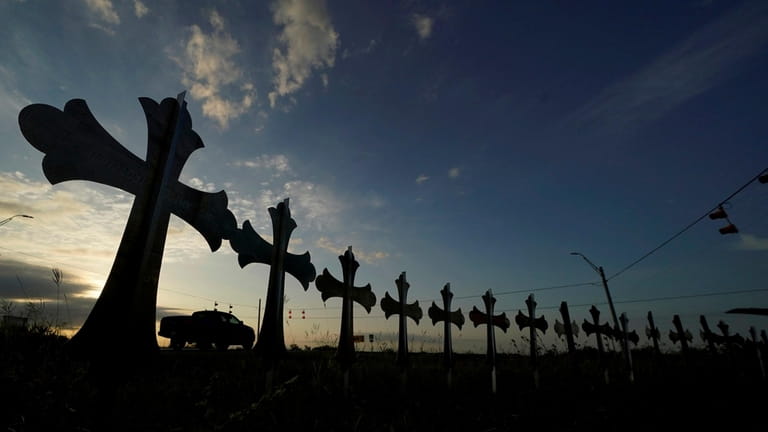 Crosses honoring the victims killed in the mass shooting in...